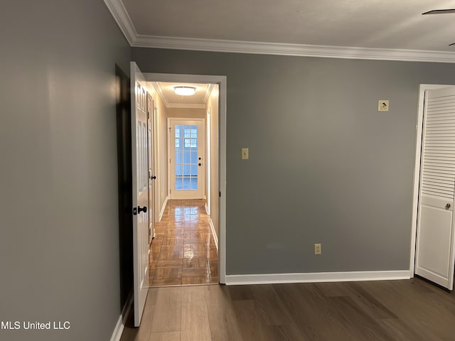 hall with dark hardwood / wood-style flooring and crown molding