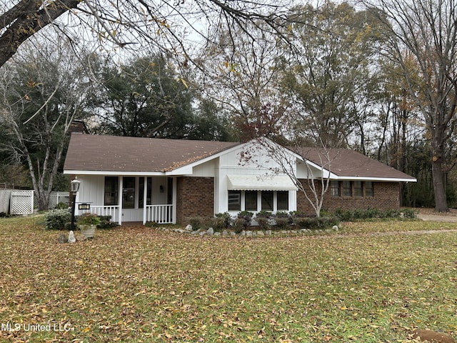 single story home featuring a front yard and covered porch