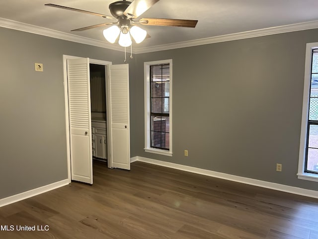 unfurnished bedroom with dark hardwood / wood-style flooring, ceiling fan, and ornamental molding