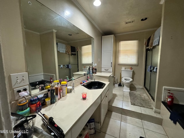 bathroom featuring tile patterned flooring, vanity, toilet, and crown molding