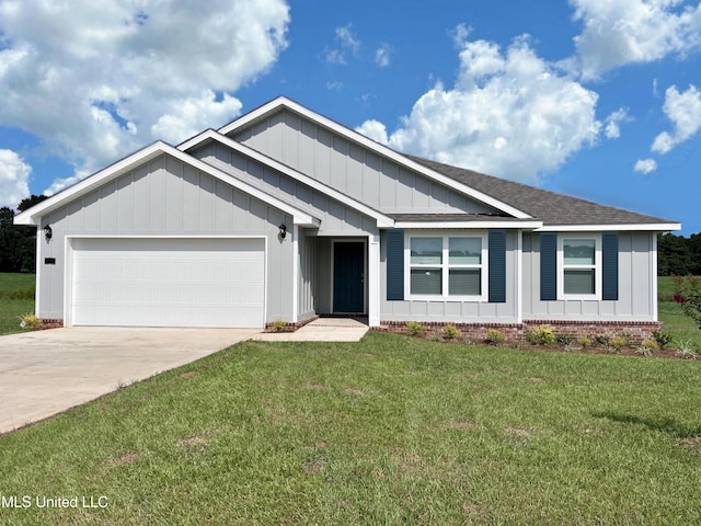 view of front of house featuring a garage and a front lawn