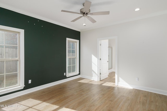 unfurnished room featuring crown molding, light hardwood / wood-style flooring, and ceiling fan