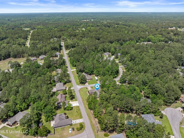 aerial view of property and surrounding area with a forest