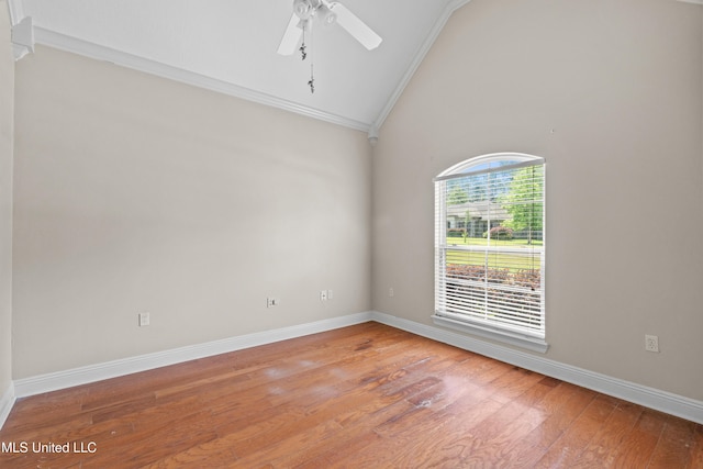 unfurnished room featuring vaulted ceiling, crown molding, light wood-style floors, ceiling fan, and baseboards