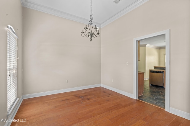 unfurnished dining area with a chandelier, ornamental molding, baseboards, and wood finished floors