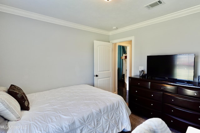 bedroom with crown molding and carpet