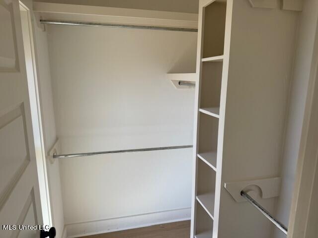 spacious closet featuring hardwood / wood-style floors