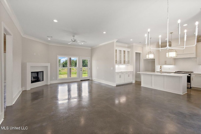 850 Glenwild Cir, Canton, MS 39046 - unfurnished living room featuring a sink, concrete floors, baseboards, ornamental molding, and a ceiling fan