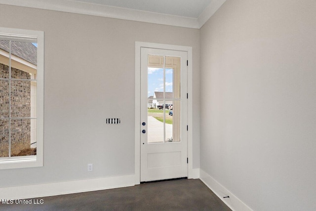 850 Glenwild Cir, Canton, MS 39046 - doorway with baseboards, plenty of natural light, finished concrete floors, and ornamental molding