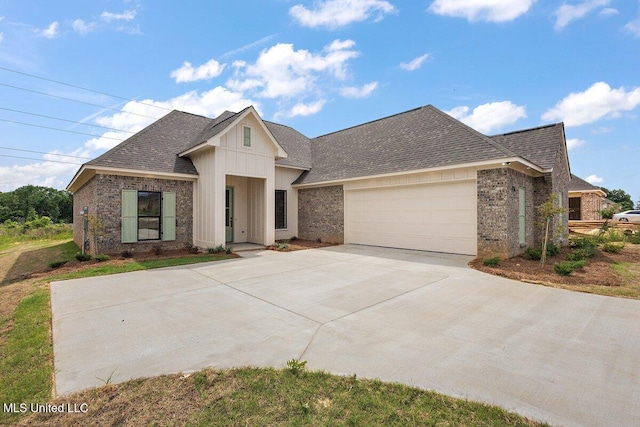 850 Glenwild Cir, Canton, MS 39046 - view of front of property with a garage, brick siding, roof with shingles, and driveway