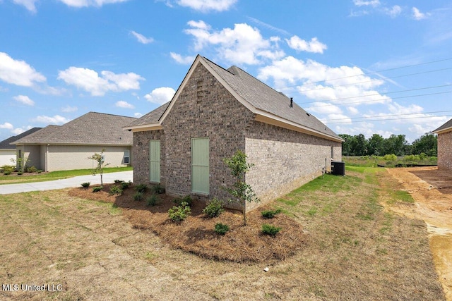 850 Glenwild Cir, Canton, MS 39046 - view of side of home featuring brick siding, central AC, roof with shingles, and a lawn