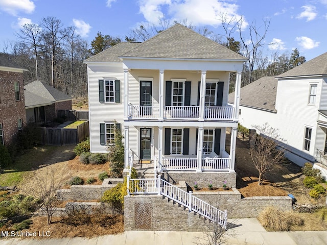 greek revival house featuring a porch, stairway, a shingled roof, and a balcony