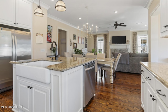 kitchen featuring stainless steel appliances, dark wood finished floors, ornamental molding, and a sink