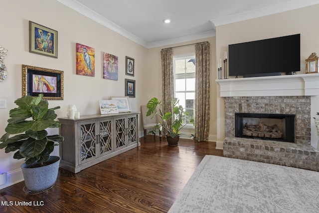 sitting room with ornamental molding, a fireplace, baseboards, and wood finished floors