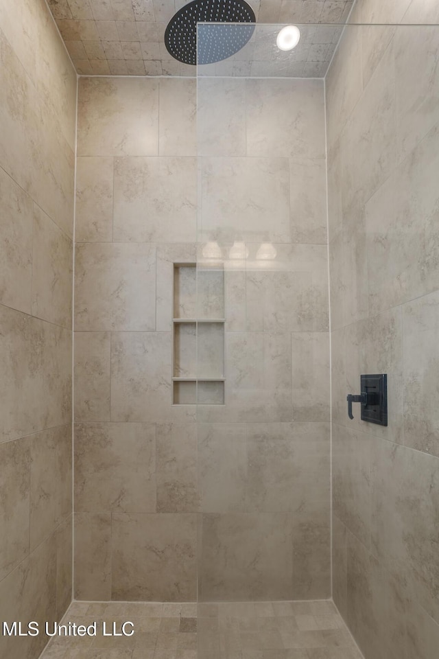 bathroom with a tile shower