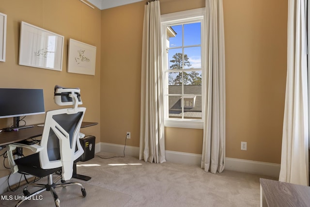 carpeted home office with baseboards