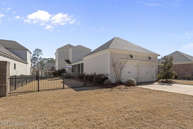 view of property exterior featuring a lawn, concrete driveway, roof with shingles, an attached garage, and fence