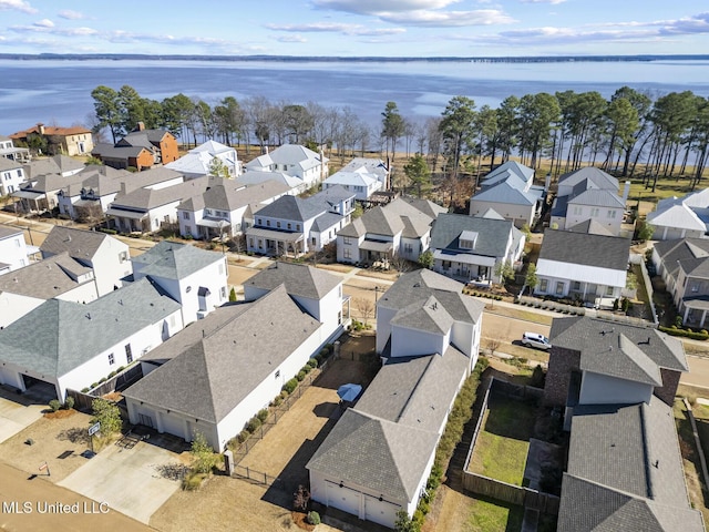 birds eye view of property featuring a water view and a residential view