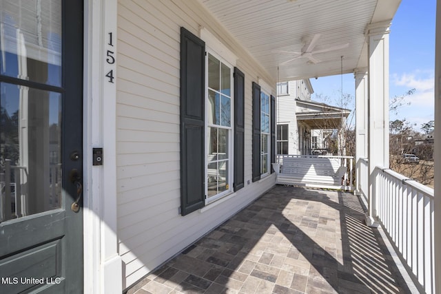 balcony featuring covered porch and ceiling fan