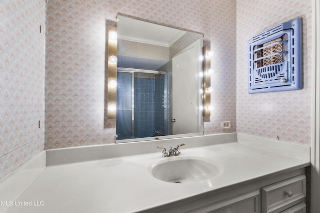 bathroom with vanity, crown molding, and walk in shower