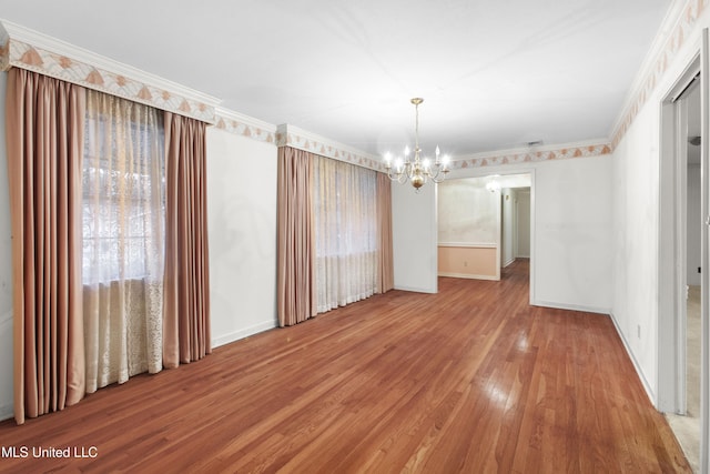 unfurnished dining area with an inviting chandelier, wood-type flooring, and ornamental molding