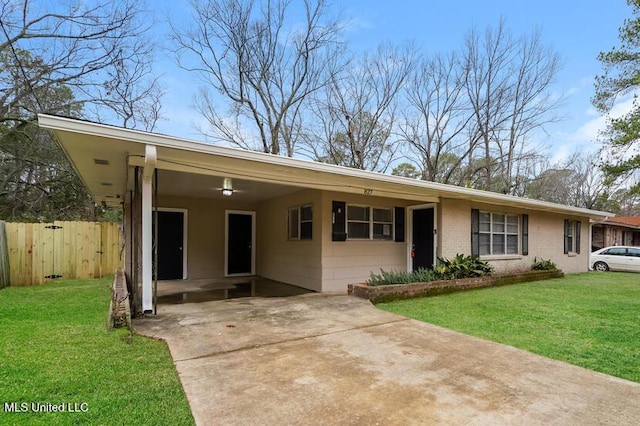 view of front of property featuring an attached carport, concrete driveway, a front yard, and fence