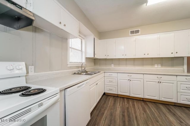 kitchen with a sink, white appliances, white cabinetry, and light countertops