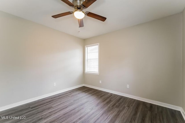 unfurnished room with baseboards, dark wood-style flooring, and ceiling fan