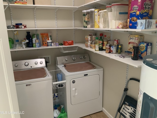 laundry room with washer and dryer, laundry area, water heater, and light tile patterned floors