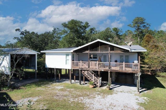 rear view of property featuring a deck