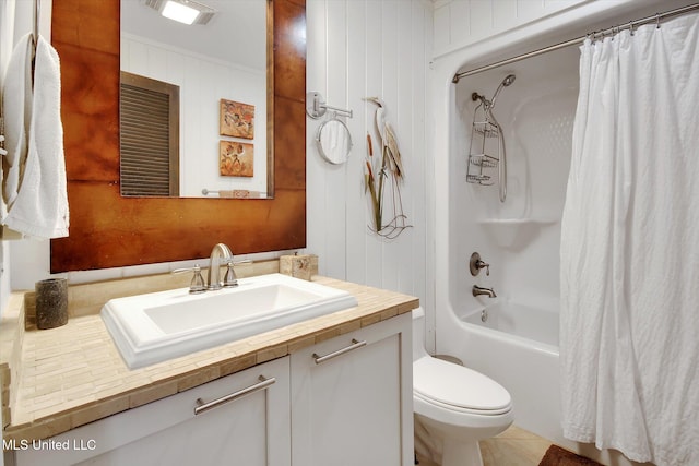 full bathroom featuring shower / bath combo, tile patterned flooring, crown molding, toilet, and vanity