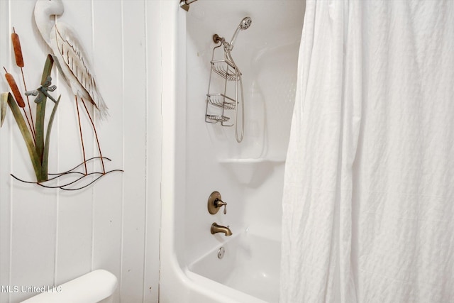 bathroom with shower / bath combo with shower curtain