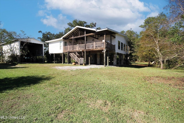 rear view of property featuring a yard, a deck, and ceiling fan