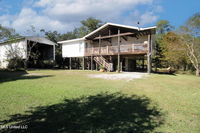 back of property featuring a carport, a yard, and a wooden deck