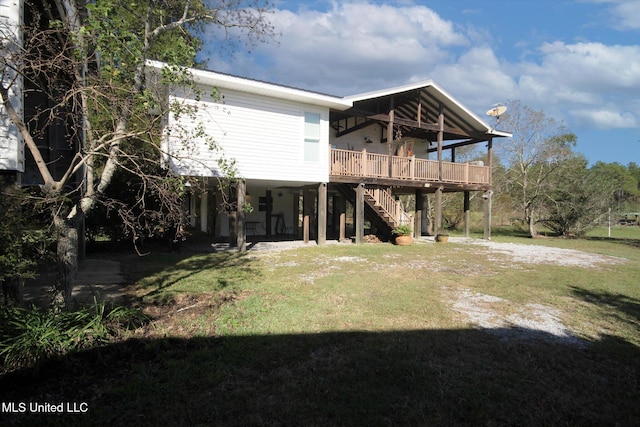 rear view of house with a lawn and a wooden deck