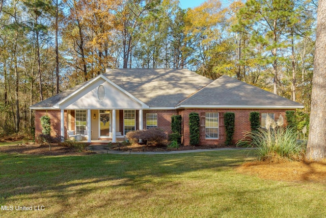 single story home featuring covered porch and a front yard