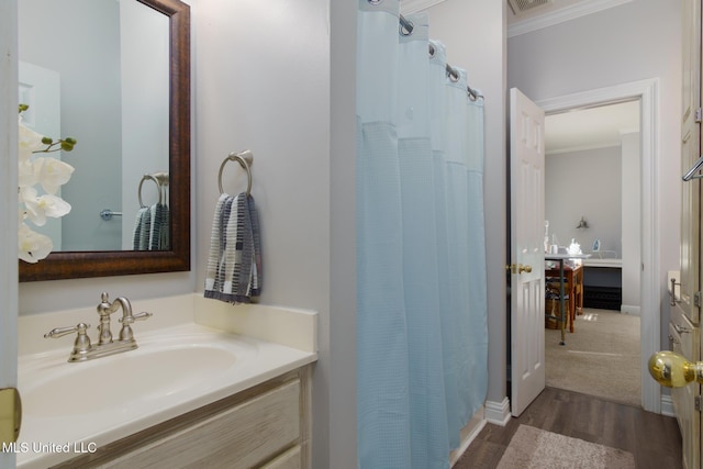 bathroom with vanity, hardwood / wood-style flooring, curtained shower, and crown molding