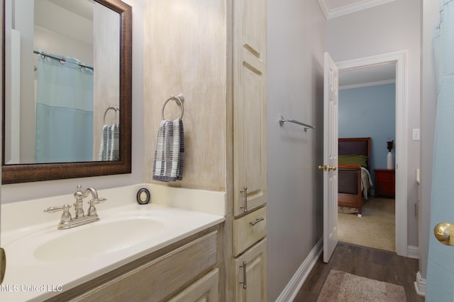 bathroom featuring wood-type flooring, vanity, curtained shower, and crown molding