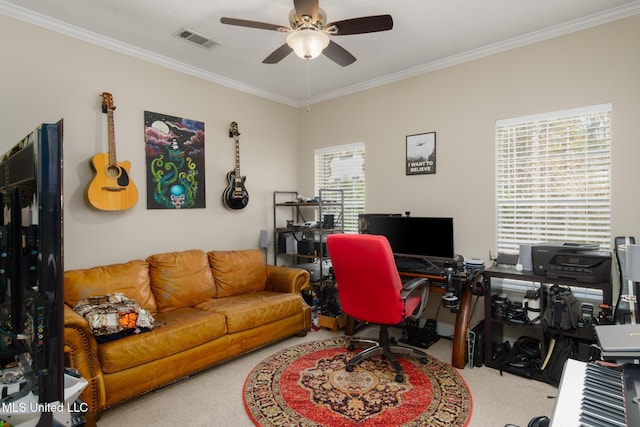 carpeted office space featuring ceiling fan, a healthy amount of sunlight, and ornamental molding