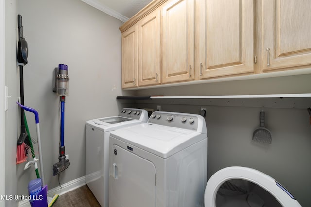 laundry area featuring cabinets, separate washer and dryer, ornamental molding, and dark wood-type flooring