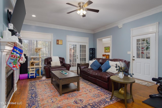 living room with ceiling fan, french doors, crown molding, and dark hardwood / wood-style floors