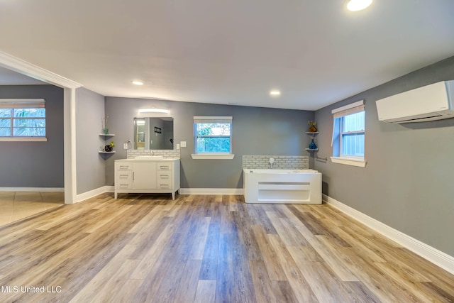 bathroom with a tub, a wall mounted air conditioner, backsplash, hardwood / wood-style floors, and vanity