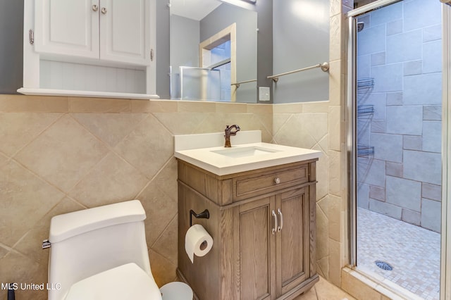 bathroom featuring an enclosed shower, vanity, toilet, and tile walls