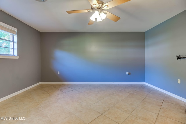 empty room featuring ceiling fan and light tile patterned floors