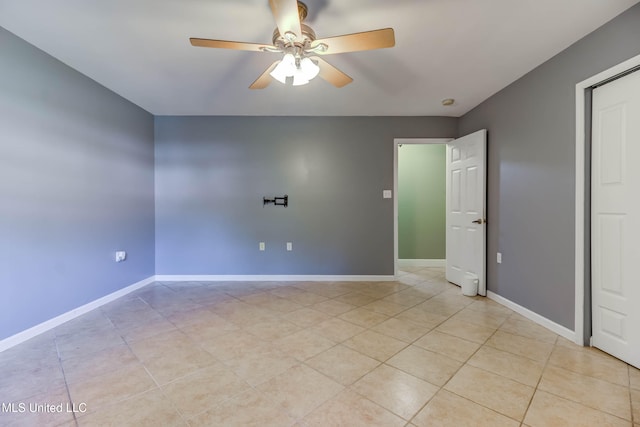 tiled empty room with ceiling fan