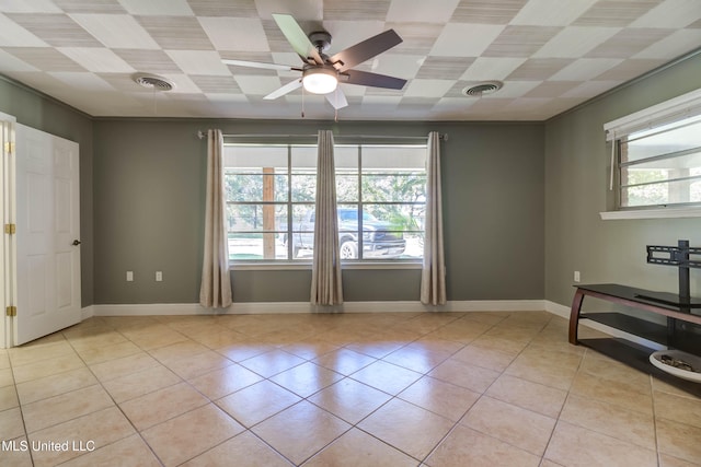 spare room with ceiling fan and light tile patterned flooring