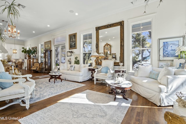 living room featuring visible vents, wood finished floors, crown molding, a chandelier, and recessed lighting