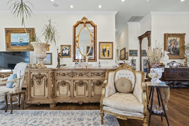 sitting room with ornamental molding, visible vents, and dark wood finished floors