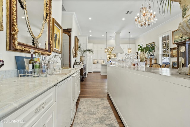 kitchen featuring ornamental molding, dark wood-style flooring, a sink, and visible vents