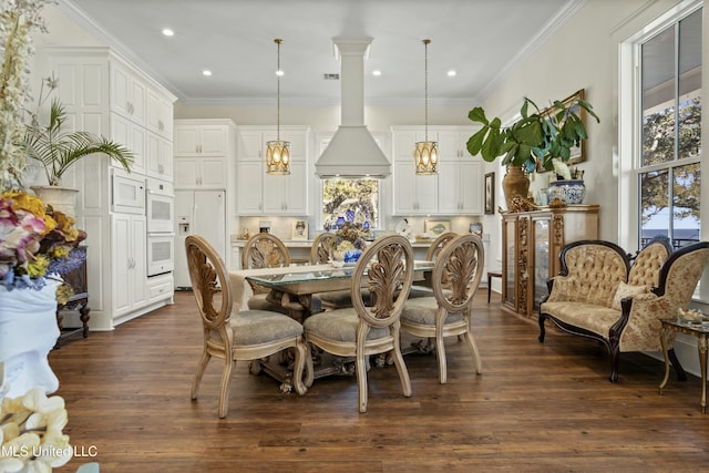 dining room with dark wood-style floors, recessed lighting, and crown molding